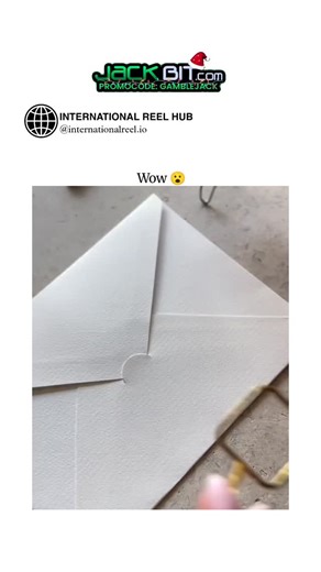 🌍 INTERNATIONAL REEL HUB on Instagram: "This ASMR video showcases a hybrid DIY technique for sealing envelopes: using a glue gun to attach a gold frame to the flap, followed by blue sealing wax and a custom stamp for an elegant, textured finish. Posted December 19, 2025, by @asmrvideo_ —a curator of relaxing content—it amassed 581,000 views and 722 likes within 48 hours, highlighting the niche appeal of tactile, sound-rich crafts in the ASMR space. User reactions, mostly from Indonesian speaker