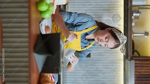 Asian Female Chef learn how to bake bread. Online Video Class, Streaming Service of e-Learning Video Course.bread Recipe Preparation study from tablet online course in kitchen vertical shot