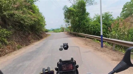 Motorcycle rider crashes on rural cliffside road in Guangxi, China