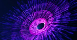 Abstract glowing e particles flying in a spiral in a whirlwind of energy, magic particles sparkle and swirl on an abstract background. Video 4k