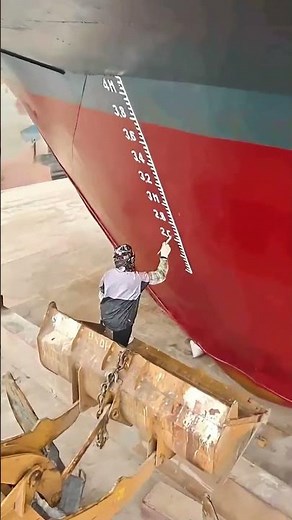 Engineers Marking Waterline Indicators at a Shipyard