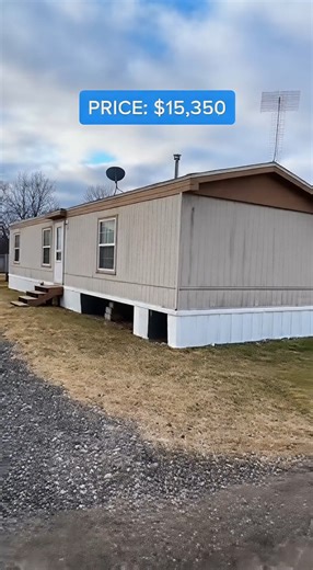 used manufactured home listed at $15,350 From the outside, the unit shows age but sits level with a straight roofline and sealed windows. Inside, the flooring feels firm and the layout opens up more than expected. The kitchen appears early in the layout, with worn but functional cabinets and working plumbing. The living area offers enough width for everyday furniture without feeling tight. The bathroom works properly, though the exhaust fan is weak. The bedroom at the end of the unit provides pr