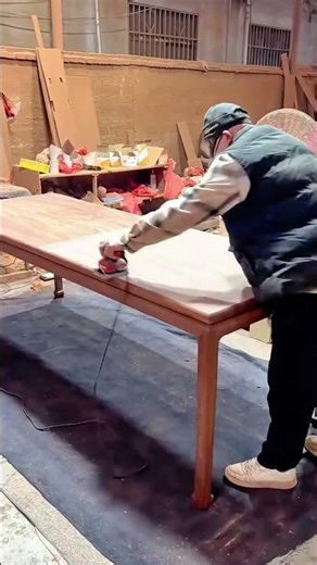 sanding the surface of a wooden table using a sander to make it look very smooth and also neat too