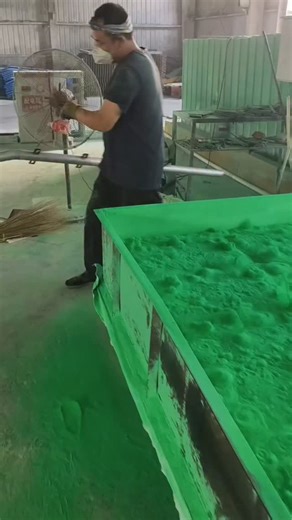techy Universe on Instagram: "An industrial powder processing and leveling operation. A worker is carefully spreading and smoothing bright green powder inside a large tray using a hand tool. The process helps maintain uniform thickness, remove air gaps, and ensure consistent quality before the next production stage. Safety measures like gloves and a face mask are used to protect against fine particles. Such operations are common in pigment preparation, powder coating, chemical processing, or mat