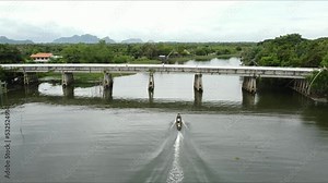 Tourist service boat and giant fishing construction trap in Pak Pra fishing village, Phatthalung, THAILAND. (2.7K resolution footage by drone)