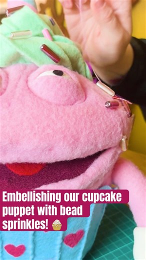 Embellishing our cupcake puppet with bead sprinkles! 🧁