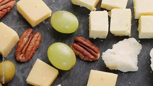 Italian or Spanish cheese plate in restaurant with traditional tapas food, Spanish cuisine, delicious tapas and cheese plate, bruschetta with cheese, olives grape and walnut