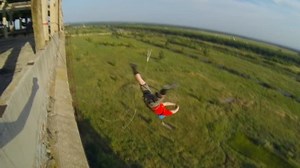 jump from the 15th floor high-rise building with hanging 20 meters above the ground on a system of climbing ropes