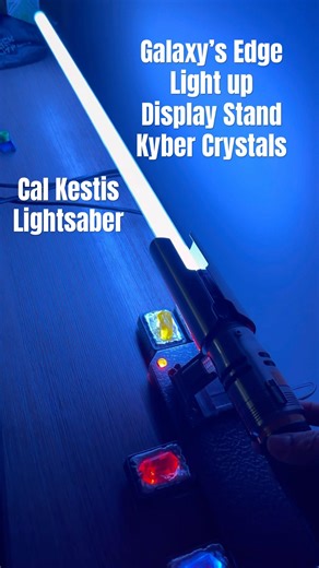 Cal Kestis lightsaber atop light up Galaxy’s edge display stand and kyber crystals