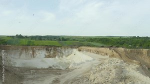 Sand Quarry For The Extraction Of Stone And Sand. A heavy machinery - excavator in the Sand Quarry