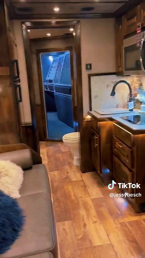 Signature Quarters, Custom Living Quarters pulled out ALL the stops on this stunner for Trailers Unlimited! This is a Platinum four-horse side load, 17’6” short wall with 7’ slide, and it is LOADED with unique style and amenities. Front and center is a stunning entertainment center complete with a fireplace. A large U-lounge features a boot-stitch accent and electric table leg, and a large sofa and fold-down bunk create even more sleeping space. They went all in on design with unique touches lik