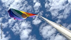 Cusco Flag Waving, Peru. Inka Rainbow flag of Cusco Peru blows in the wind on a blue sky day. Tahuantinsuyo flag