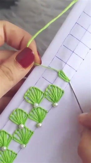 embroidery process sewing green flower patterns on white fabric