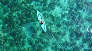 Woman On A Kayak Paddling On Turquoise Paradise Beach At El Nido, Palawan Island, Philippines. - Aerial Ascending Shot