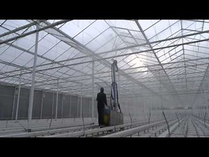 Cleaning and disinfection of a greenhouse with the AquaJet greenhouse roof cleaner