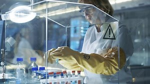 Senior Female Biologist Works with Samples in Isolation Glove Box. She's in a Modern Laboratory Equipped with State of the Art Technology. Shot on RED EPIC-W 8K Helium Cinema Camera.