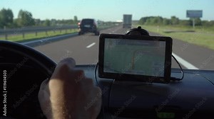 GPS navigation in car with man driving 4K. Close up on navigation screen showing road to follow. Smartphone navigation device.