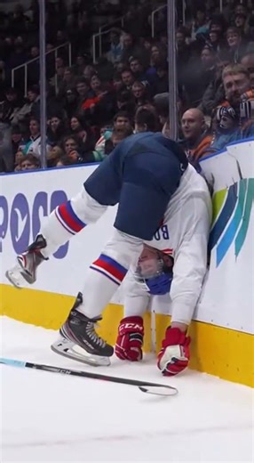 Hockey player carthwheel into the boards