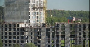 Crane At Work. Timelapse Construction And Development Of New Multi-storey Residential Buildings. Real Estate. Construction Crane Is Involved In Construction Of New Multi-storey Residential Houses.