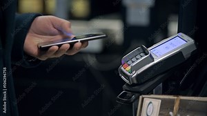 Contactless payment with your smartphone. Paying with a smartphone device on a credit card terminal. Wireless payment