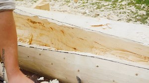 Cutting a wooden log with an axe