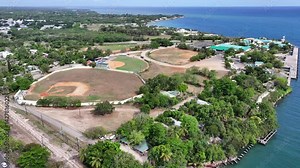 La Romana, Dominican Republic, flying around La Romana sports stadiums and Cruise Terminal with pier and buildings in background, located at Rio Dulce river mouth - 4K aerial video footage