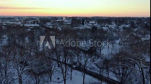 Snow covered beautiful countryside town of Lititz in Pennsylvania, aerial push towards town
