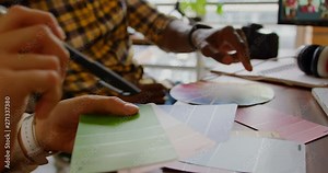 Graphic designers working together at desk in a modern office.