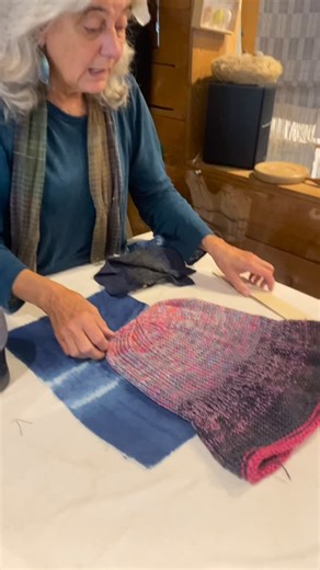 Silk Weaving Studio on Instagram: "Diana walks a studio visitor through the process of making the Lucia Hat before it’s fulled — knitted large in a 50/50 silk and wool blend. Each hat is later transformed in the wringer washing machine, where it shrinks, firms, and takes on its final sculptural shape. A favourite in the studio for its texture, character, and the joy it brings in the making. #silkweavingstudio #granvilleisland #vancouvertextiles #handmadevancouver #knittingstudio #textileprocess 