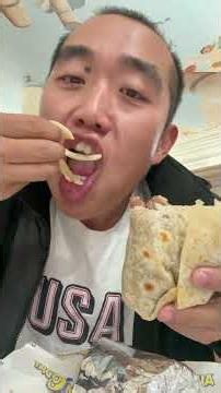 Showing and eating Veggie Burrito from Taco Mania