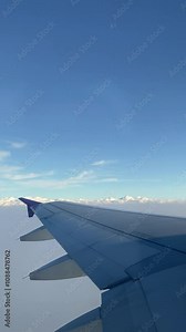 4k real time footage of airplane flight looking out from plane window. Vertical footage view from the window with silver wing of the airplane. Stock Video
