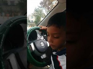 A 9 year old boy teaches how to drive a car