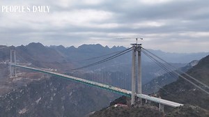 The world's tallest Huajiang Grand Canyon Bridge, standing 625 meters over the canyon in southwest China's Guizhou, has recently achieved full deck connection, a key milestone toward its scheduled opening by the end of 2025. Once operational, the bridge will cut travel time across the canyon from 70 minutes to just 1 minute by car. The 2,890-meter bridge, with a main span of 1,420 meters, is also the world's longest-span bridge built in a mountainous area. | VideoChina