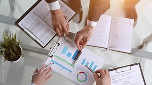 Businessman discussing with financial analyst business development strategy project. Top view photo shoot.