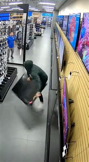 Thief gets instant karma! Phoenix, Arizona - Surveillance footage inside a department store shows a man attempting to steal a large flat-screen television while an employee is nearby. The TV appears bulky and difficult to handle as the suspect tries to maneuver it toward the store exit. As he struggles to carry the television, the man loses control and drops it onto the floor, causing visible damage. The employee watches as the attempted theft immediately falls apart due to the size and weight o