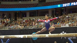 Gymnast saves herself from falling off the beam in the most impressive way possible