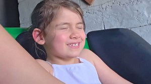 Girl goes on her first roller coaster and rides through a mix of panic and excitement