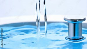 Clean water flowing from a faucet into a bright blue tub, symbolizing purity and cleanliness with a modern chrome drain stopper
