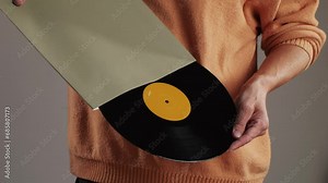 Retro Vinyl records in man hands close-up macro. Old disck for music. Retro vintage music player at home