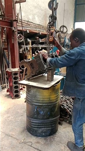 PLACING SUPPORTER UNDER TRACTOR'S ENGINE BLOCK PRIOR STICK WELDING CRACKED CYLINDER IN WORKSHOP