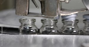 close of vaccine injection vial bottles cap or stopper putting process vial filled with medicine moving at high speed on a factory conveyer belt in a Pharma Manufacturing Company injectable drug