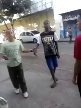 Two guys fight on top of a homeless man.