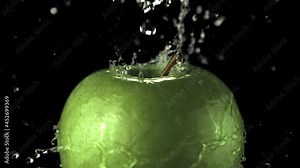 Super slow motion water drips on the rotating apple. On a black background. Filmed on a high-speed camera at 1000 fps.High quality FullHD footage
