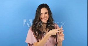 Hashtag. Woman showing hashtag symbol with fingers hands, likes tagged message, popular viral social media content, sign to follow internet online trends. Girl isolated on blue studio background.