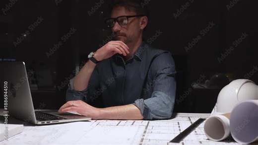 Architect or engineer working late, using a compass to draw precise measurements on blueprints and technical drawings, developing complex construction plans for a new building