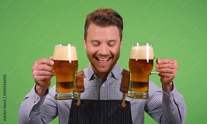young bavarian man holding two beer glasses towards camera to celebrate oktoberfest chroma key