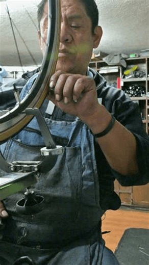 clip-4031734431-skilled-hands-adjusting-bike-wheel-spokes-alignment