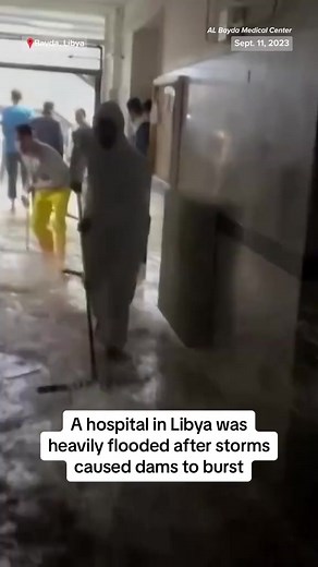Staff try to clear water from a heavily flooded hospital in Bayda, Libya, after storms caused dams to burst, leaving thousands dead or missing. | NBC News