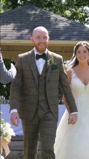 bride and groom walk up the aisle