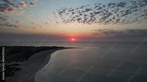 Epic sunset at Turquoise Bay Beach in Western Australia close to Exmouth. Sun over horizon and cloudy sky, Indian Ocean with panoramic view. Aerial shot.